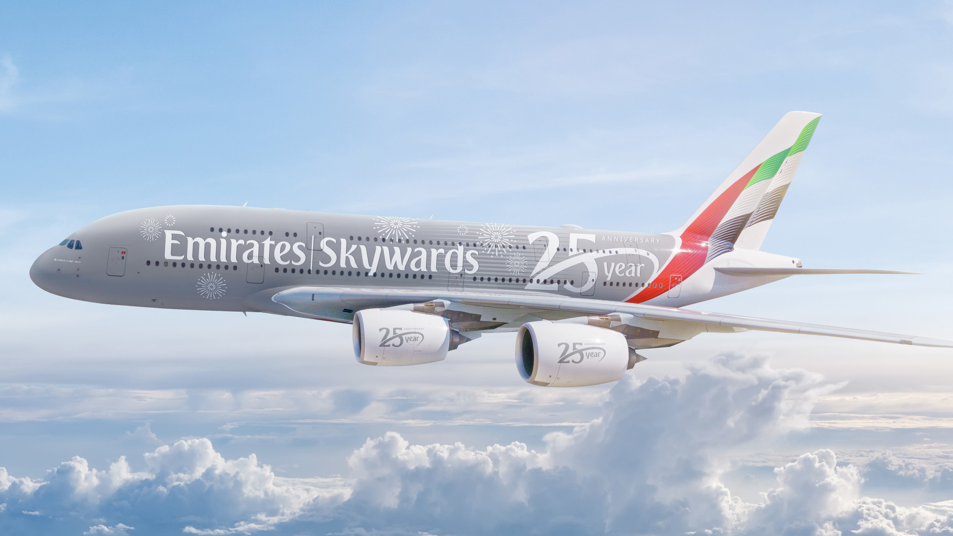 A decorated 25 year anniversary Emirates plane soaring through the clouds. ©Emirates Public Relations